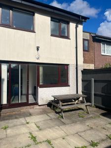 a picnic table in front of a house at BEA Allenby Walk in Manchester