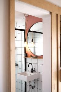 a bathroom with a sink and a mirror at Casa Mini & Casa Mia in Aljezur