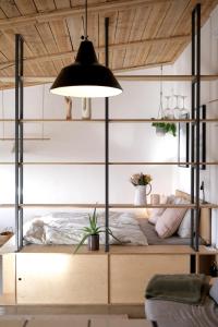 a bedroom with a bunk bed with a black lamp at Casa Mini & Casa Mia in Aljezur