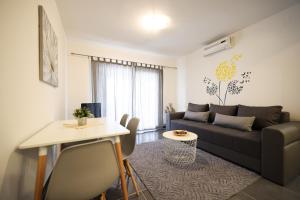 a living room with a couch and a table at Luxury Villa Nada with Pool in Petrcane