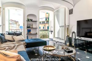 a living room with a couch and a tv at Portofino Luxury Front Marina by PortofinoVip in Portofino