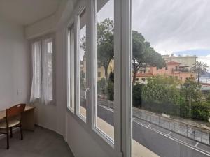 a room with windows with a view of a street at Affittacamere Montecarlo in Laigueglia +24 photos