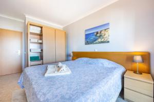 a bedroom with a blue bed with a tray on it at Clube Praia Mar Flat T1 in Portimão +34 photos