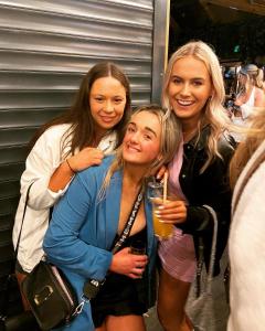 three women posing for a picture at a party at The Copper Still Bar in Dromod