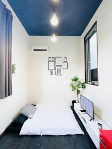 a bedroom with a white bed and a tv at Alo BnB 4 - Near SHINJUKU, SHINOKUBO - Self check-in in Tokyo