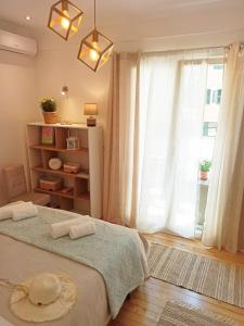 a bedroom with a bed and a large window at Elmar Apartment in Ágios Rókkos