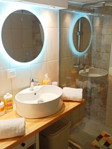 a bathroom with a sink and a mirror at Elmar Apartment in Ágios Rókkos +24 photos