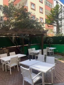 a group of tables and chairs in a patio at Ece Han Butik Otel in Atakum