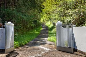 a gate on a path with a dirt road at Costa vasca in Berriatúa