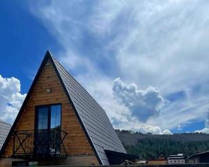 a building with a gambrel roof with a balcony at Wood Rest Tsaghkadzor in Tsaghkadzor