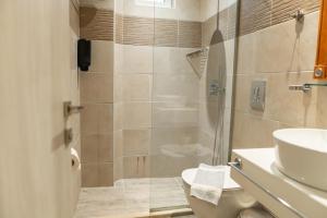 a bathroom with a shower and a toilet and a sink at Aspa Holidays in Kos