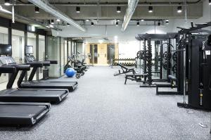 a gym with rows of treadmills and machines at Pangyo KYND Tourist Hotel - Foreign Tourist Tax Return Hotel in Seongnam