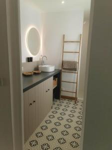 a bathroom with a sink and a vanity with a mirror at Villa la Ferlandiere in Sainte-Marie-de-Ré