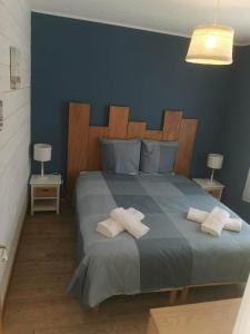 a bedroom with a large bed with two towels on it at Villa la Ferlandiere in Sainte-Marie-de-Ré