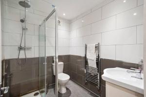 a bathroom with a shower and a toilet and a sink at Lovely Bristol Gem - Sleeps 24 in Bristol
