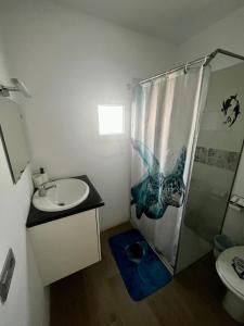 a bathroom with a sink and a shower and a toilet at Casa Rosaura in La Santa +4 photos