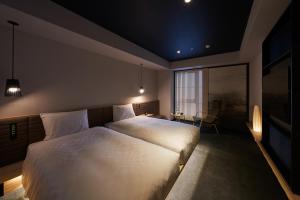 a bedroom with a large bed and a large window at Hotel Resol Trinity Osaka in Osaka