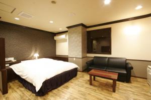 A bed or beds in a room at Hotel Joy (Adult Only)