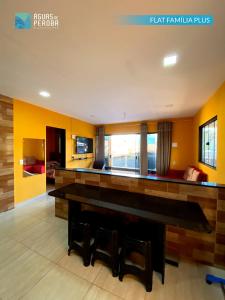 a large living room with a table and chairs at Pousada Águas de Peroba Flats e Suites in Maragogi