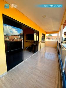 an empty balcony of a building with large glass doors at Pousada Águas de Peroba Flats e Suites in Maragogi