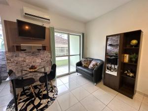 a living room with a table and a couch at Flat CasaSouza in Santa Maria