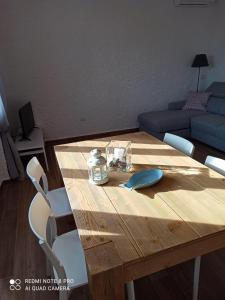 a wooden table and chairs in a living room at Il Maestrale in Isola Rossa