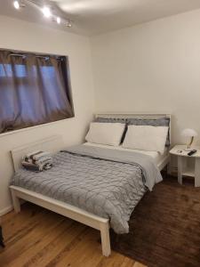 a bedroom with a bed and a window at Quality space in Havering atte Bower