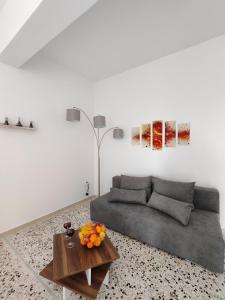 a living room with a couch and a table at Oasis Apartments in Perissa