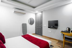 a bedroom with a bed and a flat screen tv at SaltStayz Golf Course Road in Gurgaon