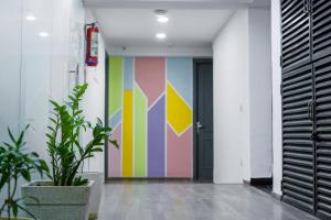 a hallway with a colorful mural on the wall at Saltstayz Express - Golf Course Road & DLF Phase-1 in Gurgaon