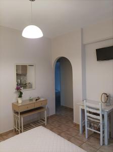 a room with a desk and a table and a chair at Studios Antoniou in Skala +76 photos