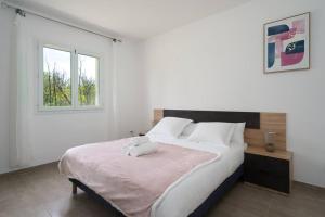 a white bedroom with a large bed and a window at Seyssuel • Villa Paisible • HostisY in Seyssuel