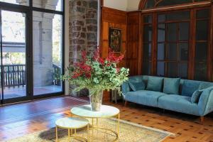 a living room with a blue couch and a vase of flowers at Bidaia Boutique Hotel in San Sebastián