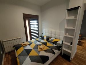 a bedroom with a bed and a book shelf at City Center Belgrade Dorćol Square in Belgrade