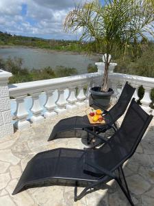 a pair of chairs and a table on a patio at Villa by the Lake in Karoubatika near Agios Ioannis in Agios Ioannis