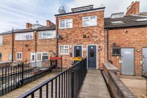 a brick building with a wooden walkway in front of it at 2 bed apartment 5 minute drive in to Nottingham city centre close to Nottingham city hospital in Nottingham