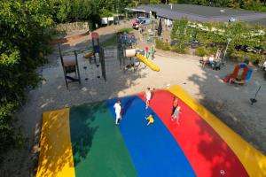 a group of people playing on a playground at Siblu Camping Meerwijck in Kropswolde