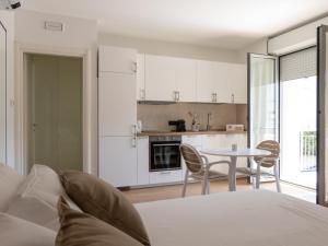 佩斯卡拉Franci Loft的一间带床的卧室和一间带桌子的厨房