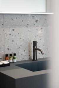 a sink with a faucet in a kitchen at Lisetta Gardens Boutique & Suites in Cisternino +71 photos
