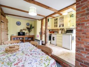 a kitchen and dining room with a table and chairs at 1 Forge Cottages in Saxmundham