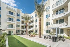 Cet appartement dispose d'une terrasse avec une pelouse et des palmiers. dans l'établissement CozySuites Paradise under the palm trees 14, à Phoenix