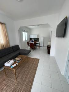 a living room with a couch and a table at Janer House at San Juan in San Juan