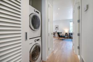 a laundry room with two washer and dryer at Georgetown 1BR w bike storage nr Waterfront WDC-89 in Washington, D.C.