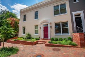 a house with a red door on a brick driveway at Georgetown 1BR w bike storage nr Waterfront WDC-89 in Washington