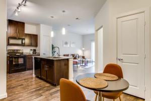 a kitchen and living room with a table and chairs at Astonishing CozySuites on I-35 with pool&parking #10 in Pflugerville