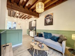 salon z kanapą i stołem w obiekcie Les Terrasses du Bouchon w Troyes +8 zdjęć