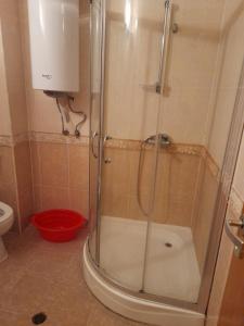 a shower with a glass door in a bathroom at Апартамент Попов in Sunny Beach