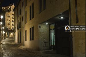 an empty street at night with a building at Apartamento Cervantes Centro Historico in Salamanca