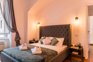 a bedroom with a bed with two towels on it at Appartamento Principe Amedeo in Rome