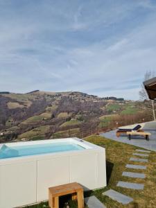 a swimming pool with a table and a bench at Narciso Home in Adrara San Rocco